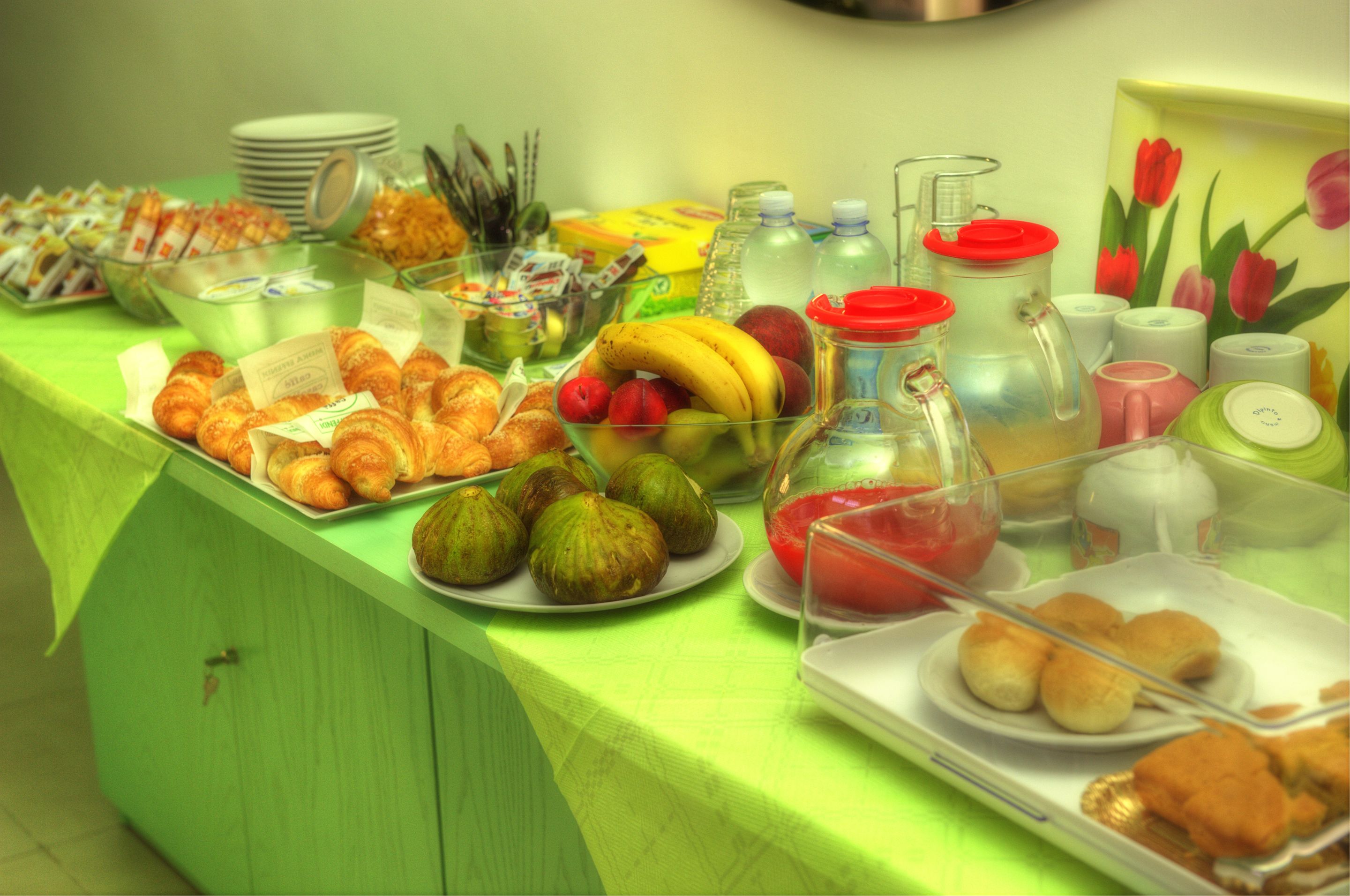 A buffet table with various food items and beverages.
