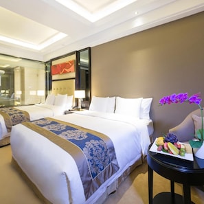 A hotel room with two beds, a bedside table with fruit, and a large window. - Dading Century Plaza Hotel (Chengdu)