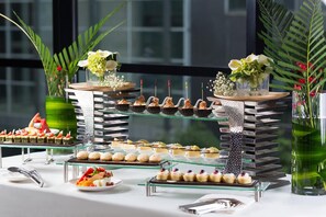 A buffet setup with various food items and decorative elements. - Dading Century Plaza Hotel (Chengdu)