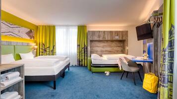 A hotel room with two beds, a desk, a chair, a TV, and a wardrobe.