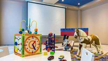 Kids can play and explore on a colorful play mat with toys and a large interactive structure.