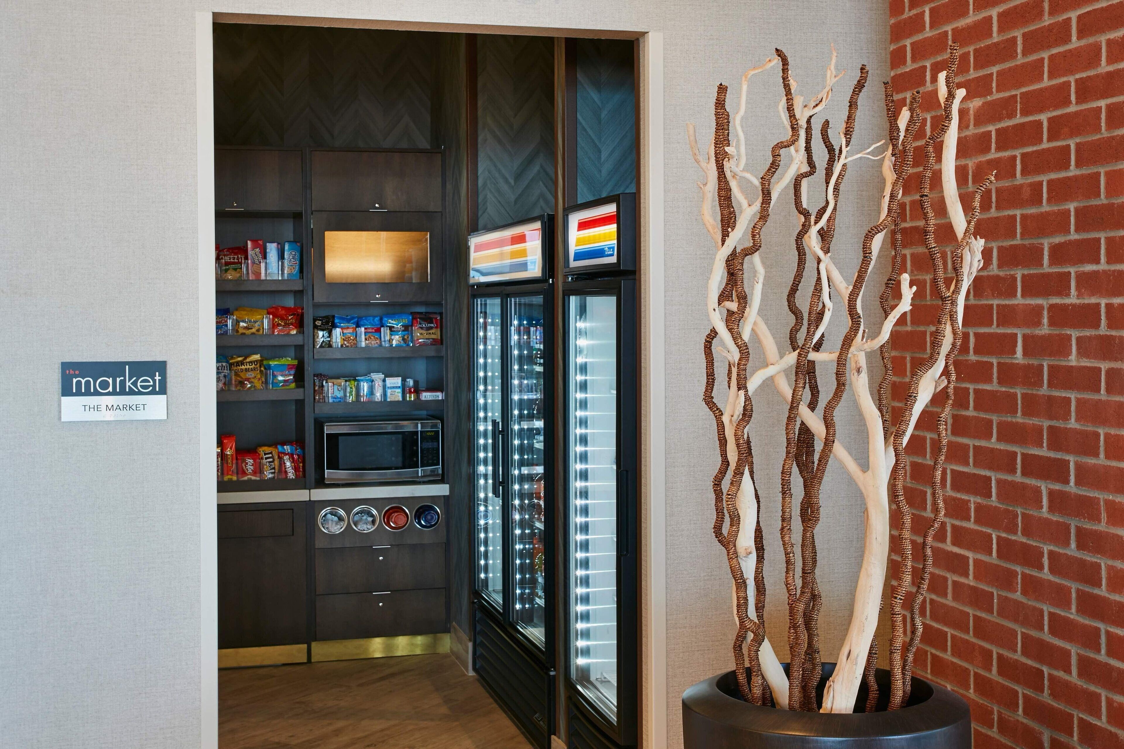 A kitchenette with a microwave, oven, and refrigerator, and a sign labeled "market".