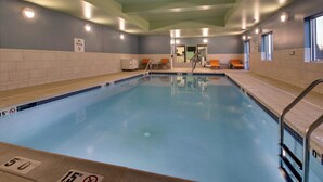 An indoor swimming pool with a no diving sign, a diving board, and a lifeguard chair. - Holiday Inn Express & Suites Lancaster East - Strasburg by IHG (Strasburg)