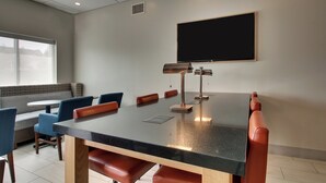 A conference room with a large table, chairs, a projector, and a screen. - Holiday Inn Express & Suites Lancaster East - Strasburg by IHG (Strasburg)