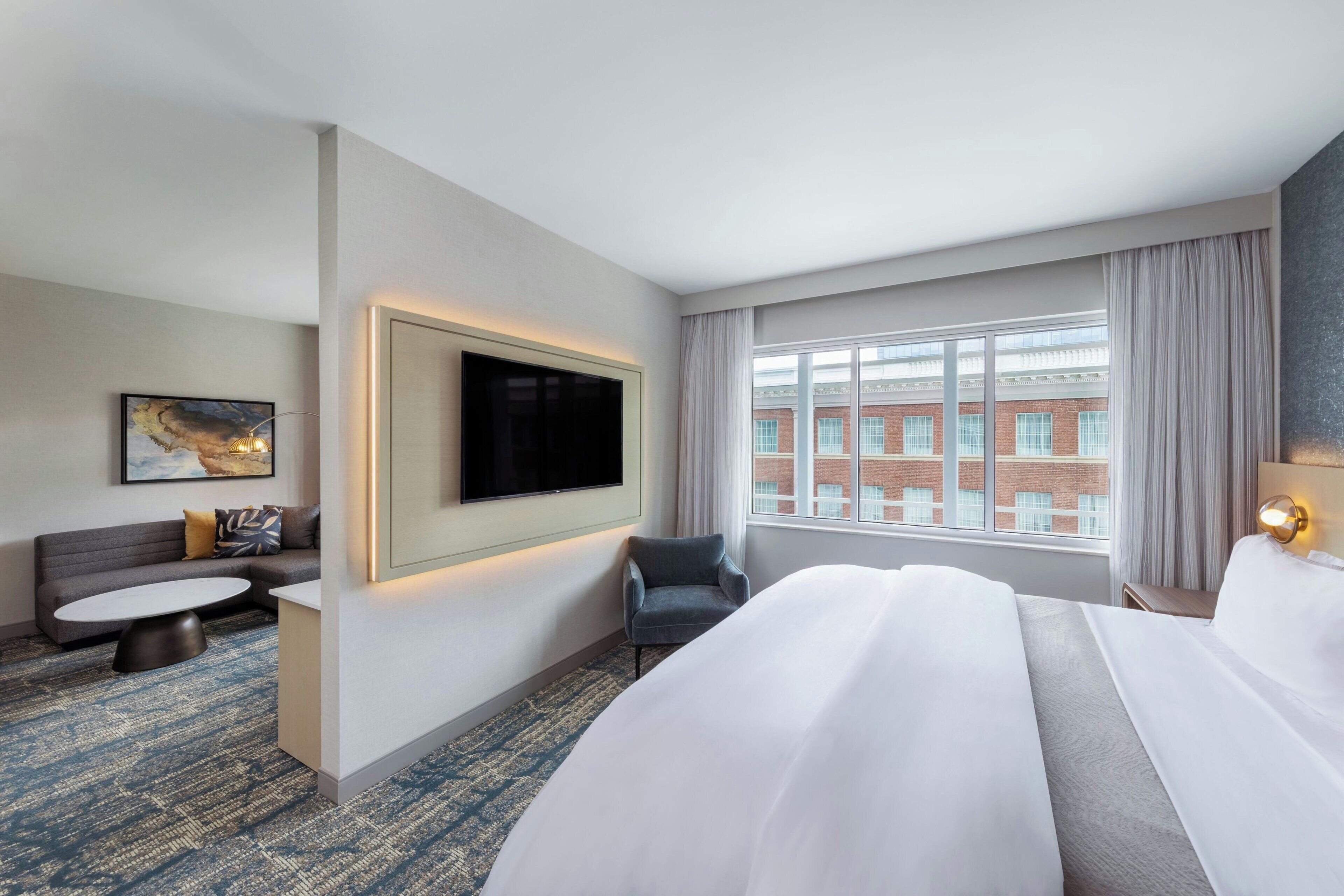 junior suite, 1 king bed, non smoking | in-room safe, desk, blackout curtains, iron/ironing board