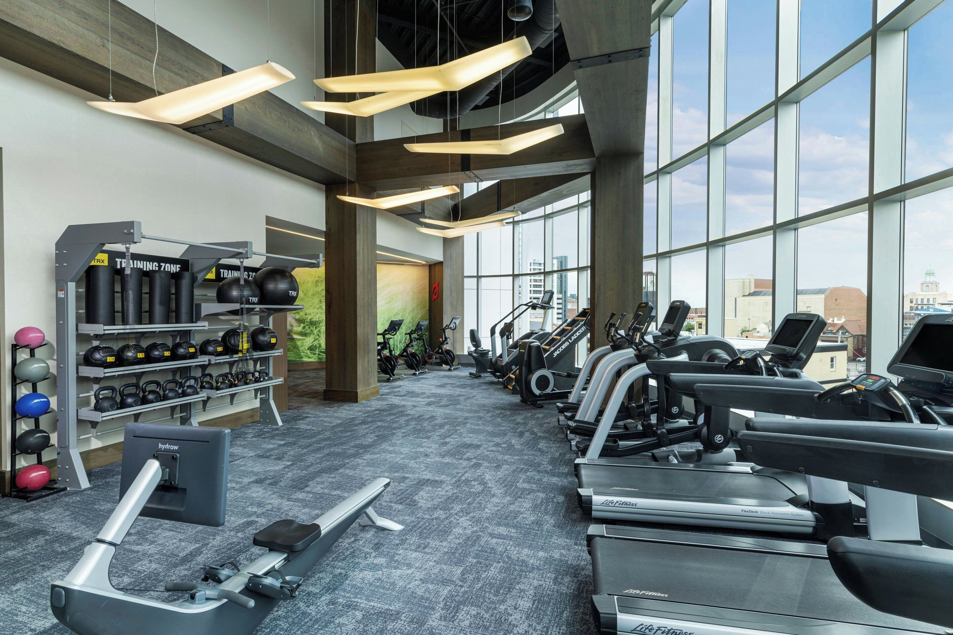 A gym with treadmills, stationary bikes, and weightlifting equipment.