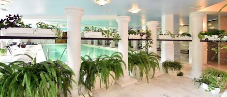 Una piscina cubierta, una piscina al aire libre de temporada, sombrillas