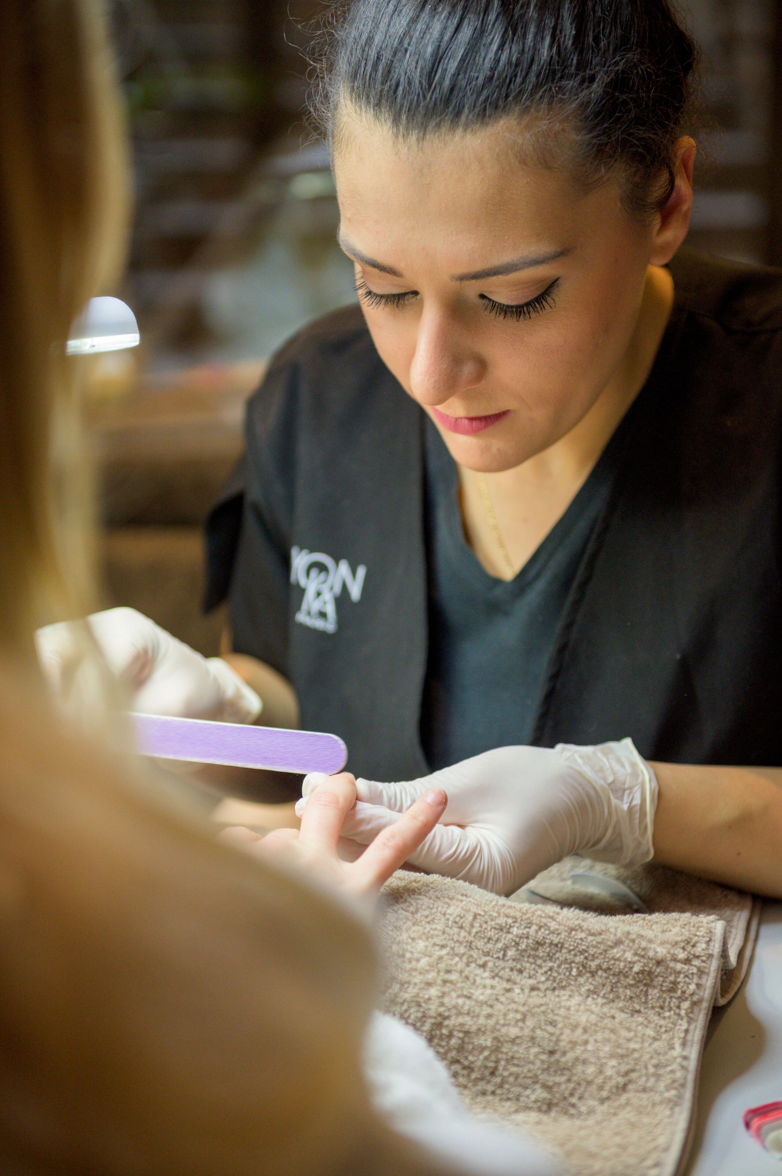 A person receiving a manicure.