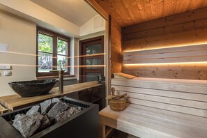 A modern kitchen with a wooden countertop, a stone bowl, and a built-in stove. - U Prejzků (Lhotka)