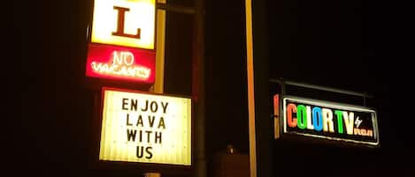 A motel sign with neon lights advertising 'Lava Spa' and 'No Vacancies'.