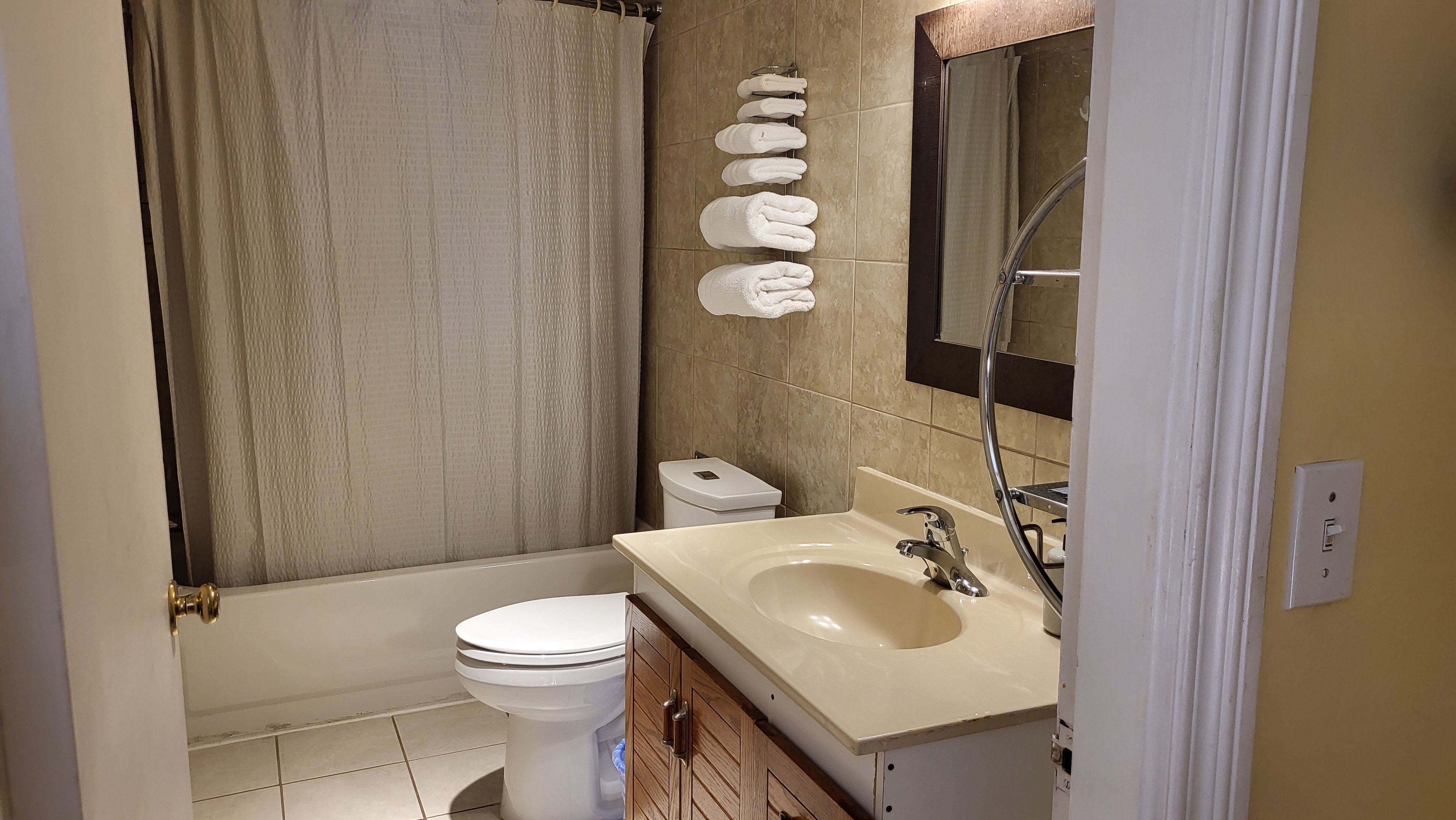 Une salle de bain avec des toilettes, un lavabo et une douche.