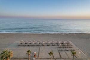 On the beach, beach cabanas, sun loungers, beach umbrellas