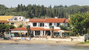 A beachfront hotel with multiple rooms, a beachside bar, and a pool area. - Akti Panela Beach Hotel (Corfu)