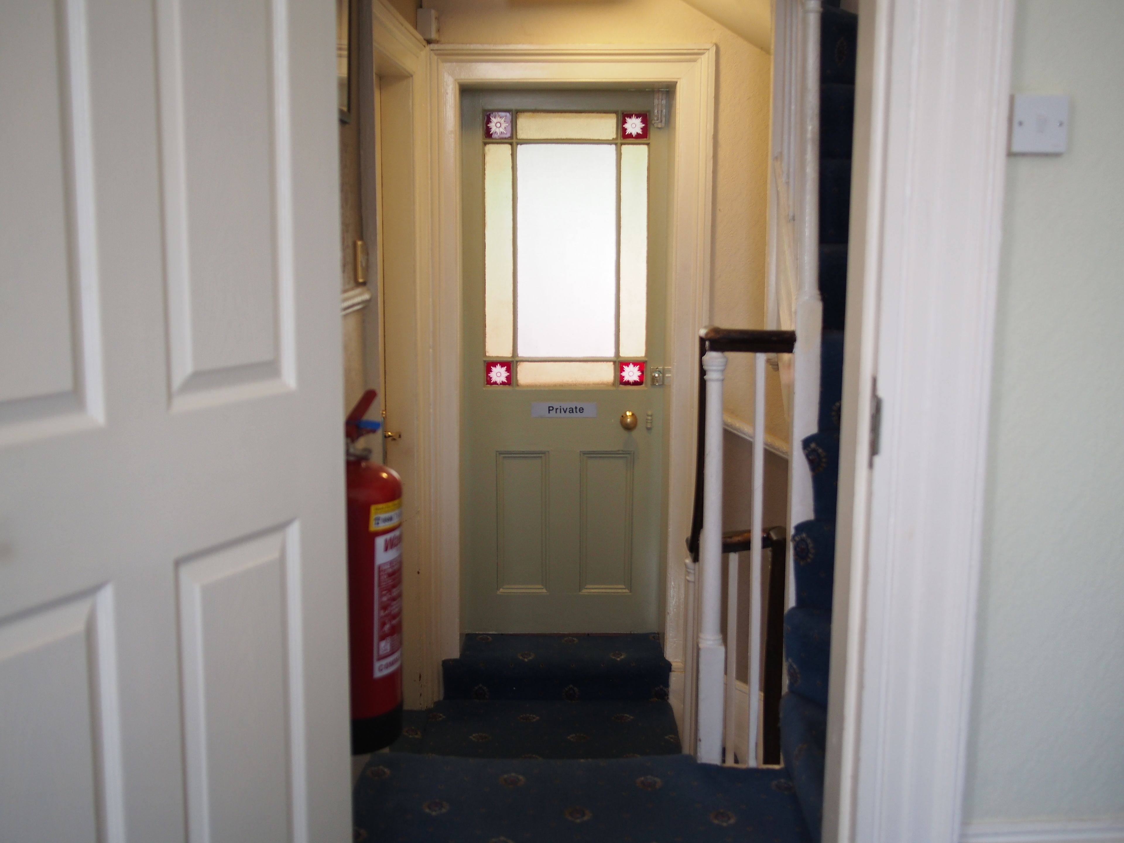 A narrow hallway with a door labeled "Private."