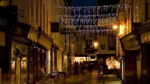 A narrow street with buildings on either side, decorated with string lights. - The Coach House Canterbury (Canterbury)
