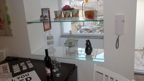 Et moderne køkken med en ø med glasplade, et spisebord med stole og udsigt udad.