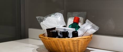 A wicker basket containing toiletries on a white surface.