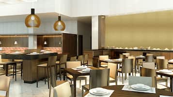 A modern restaurant with multiple dining tables and chairs, a bar area, and pendant lighting.