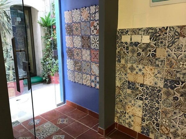 A hallway with a variety of patterned tiles on the walls and floor. - Zaman Ya Zaman Boutique Hotel (Amman)