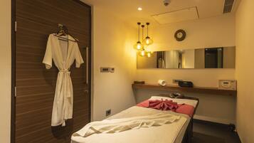 Relax in a stylish room with a made bed, wardrobe, and wall-mounted mirror.