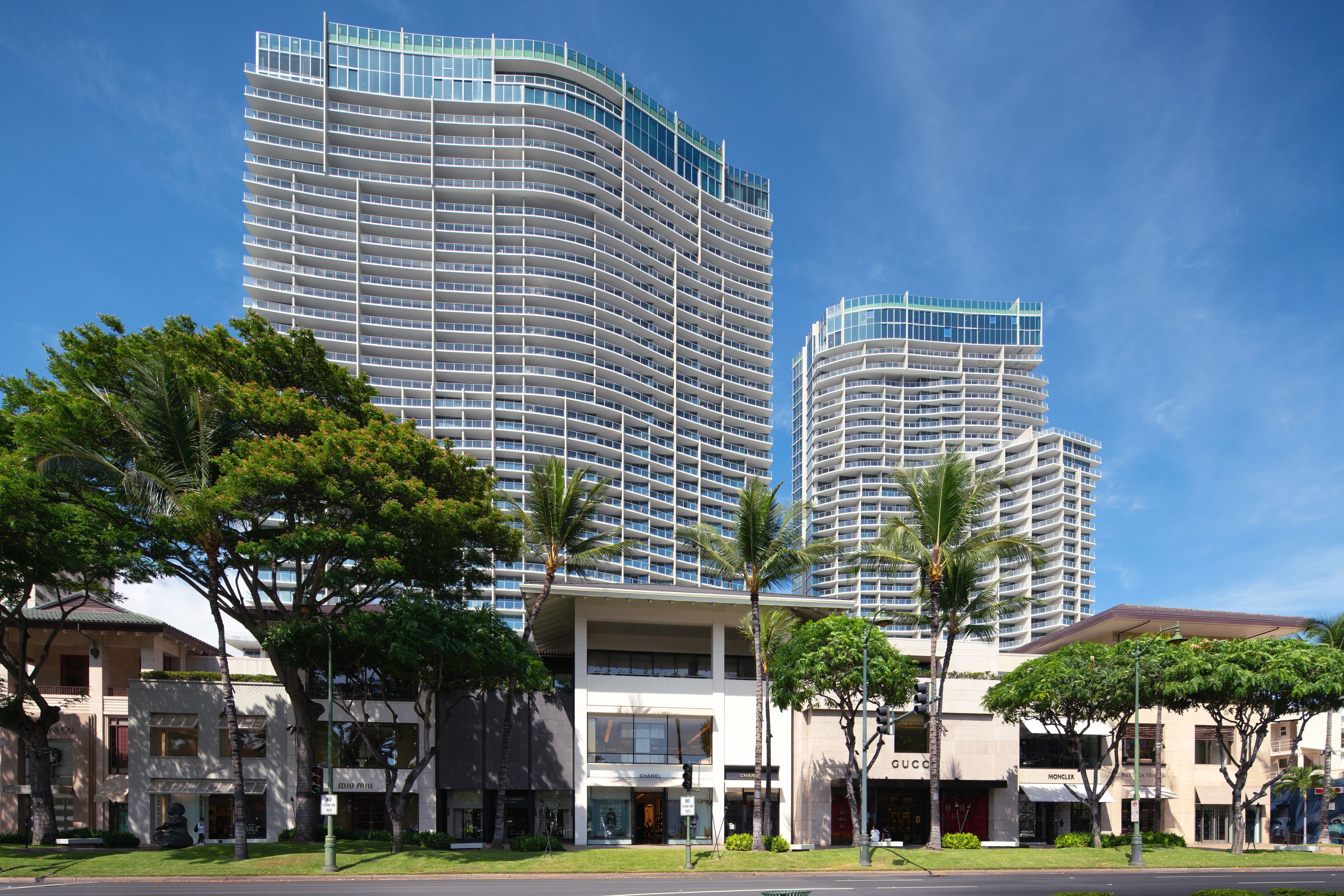 A modern hotel with multiple floors, large windows, and a prominent entrance.