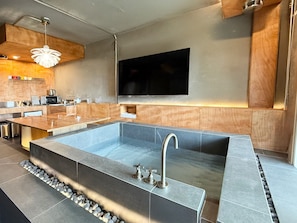 A modern kitchen with a built-in stove, microwave, and sink. - The Mauna Ocean Resort (Gyeongju)