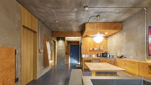 A modern kitchen with a wooden countertop, a sink, and a built-in microwave. - The Mauna Ocean Resort (Gyeongju)