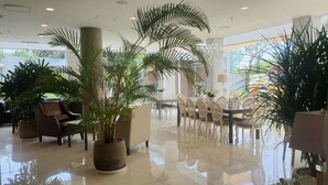 A spacious lobby with a polished floor, comfortable seating, and large potted plants. - Palgong Emillia Hotel (Daegu)