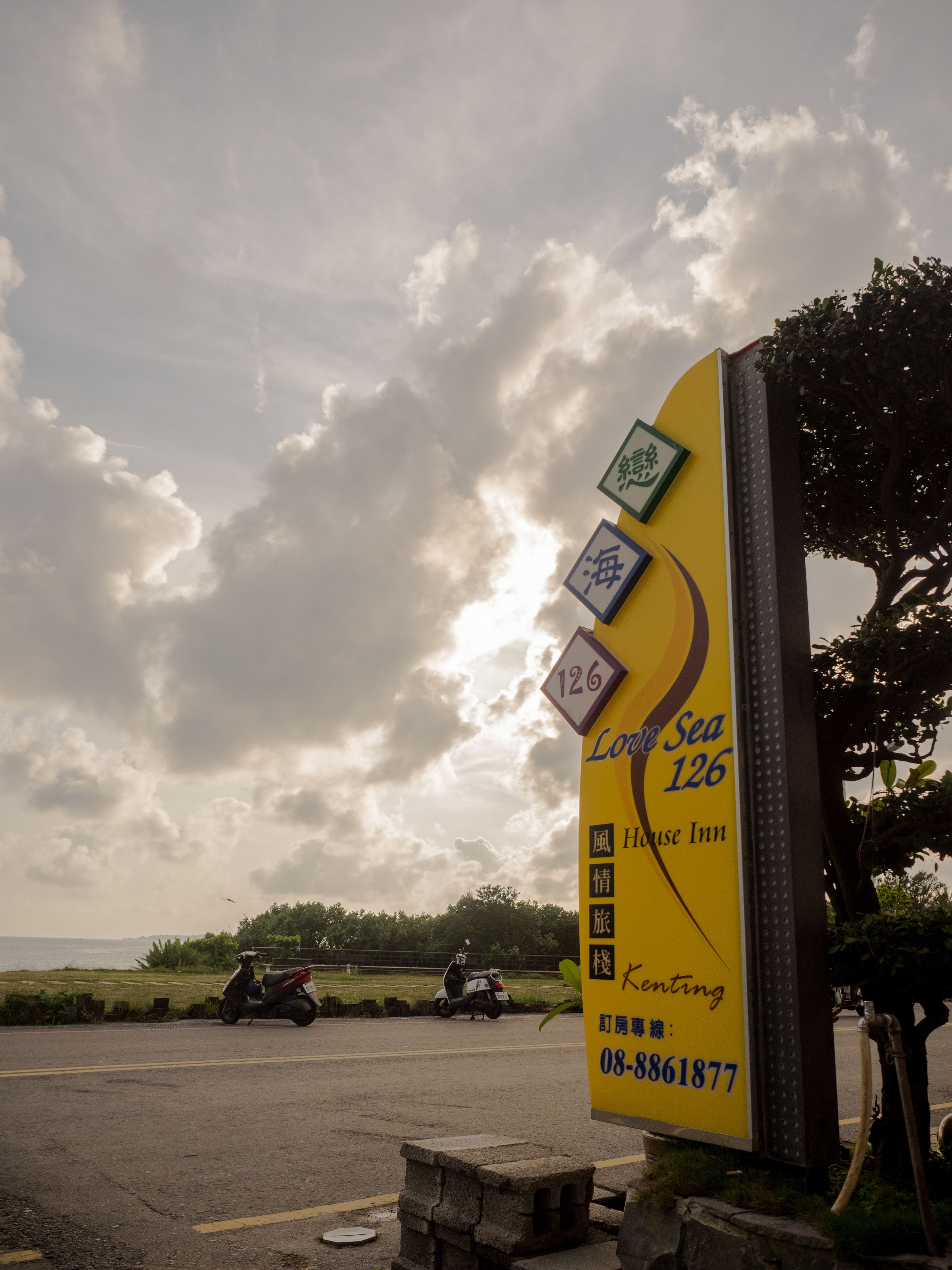 A yellow sign with "Love Sea 126" and "House Inn" indicating a hotel.