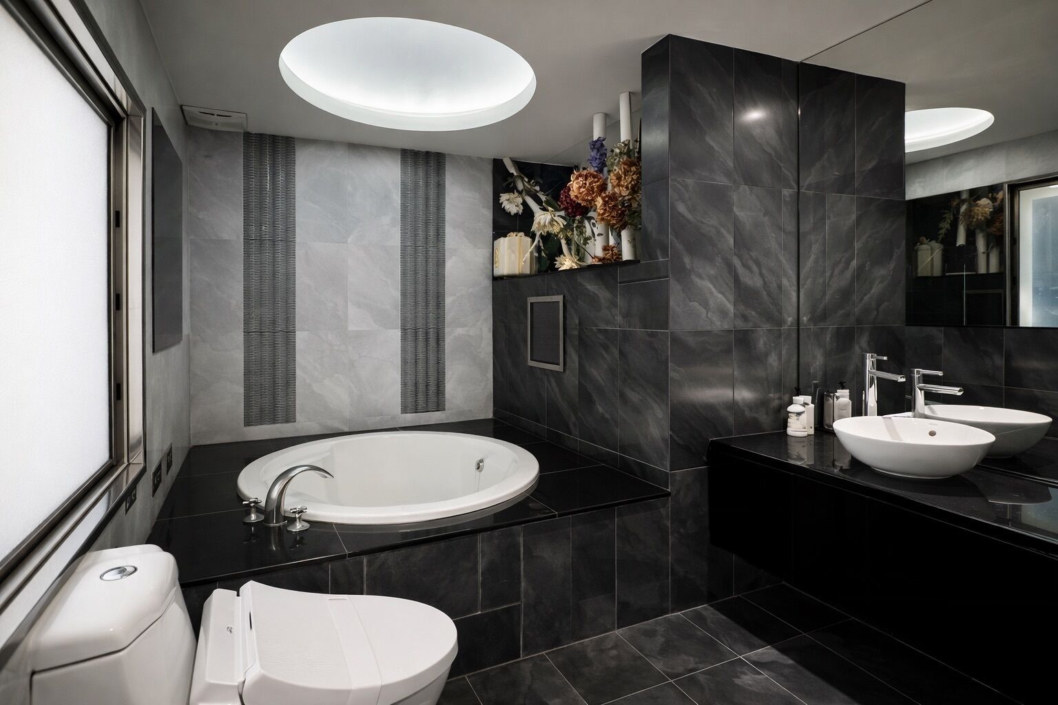 A modern bathroom with a freestanding bathtub, two sinks, and a toilet.