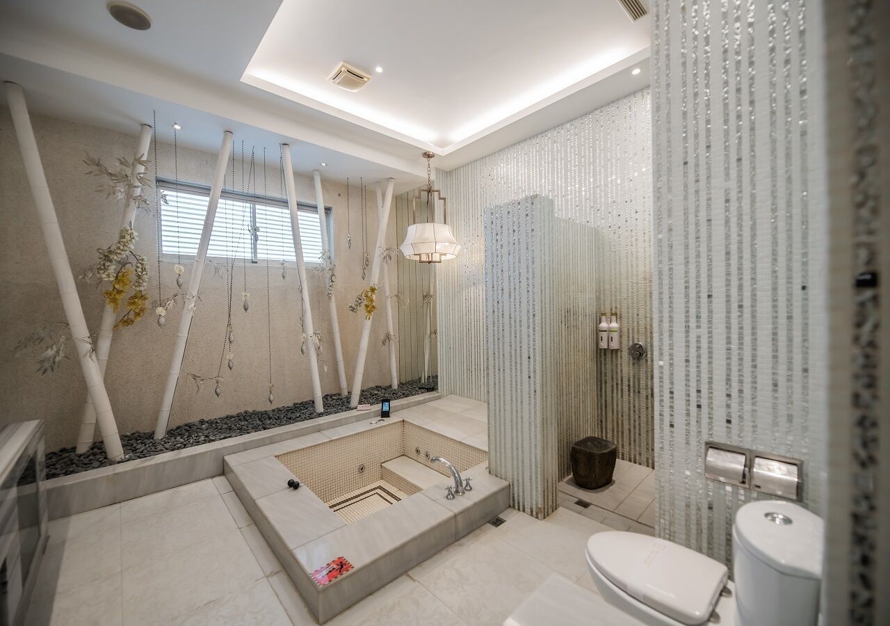 A modern bathroom with a freestanding bathtub, a toilet, and a sink.
