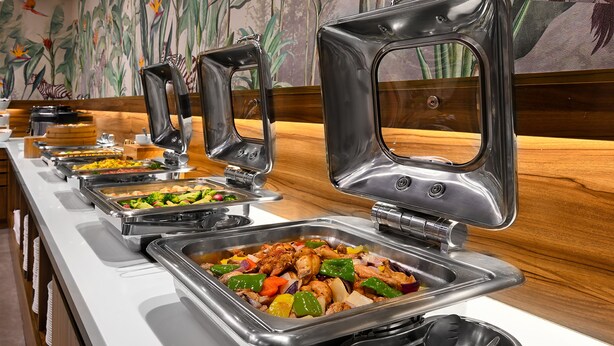 A buffet setup with various food items and utensils. - Le Room Hotel Taoyuan (Taoyuan City)