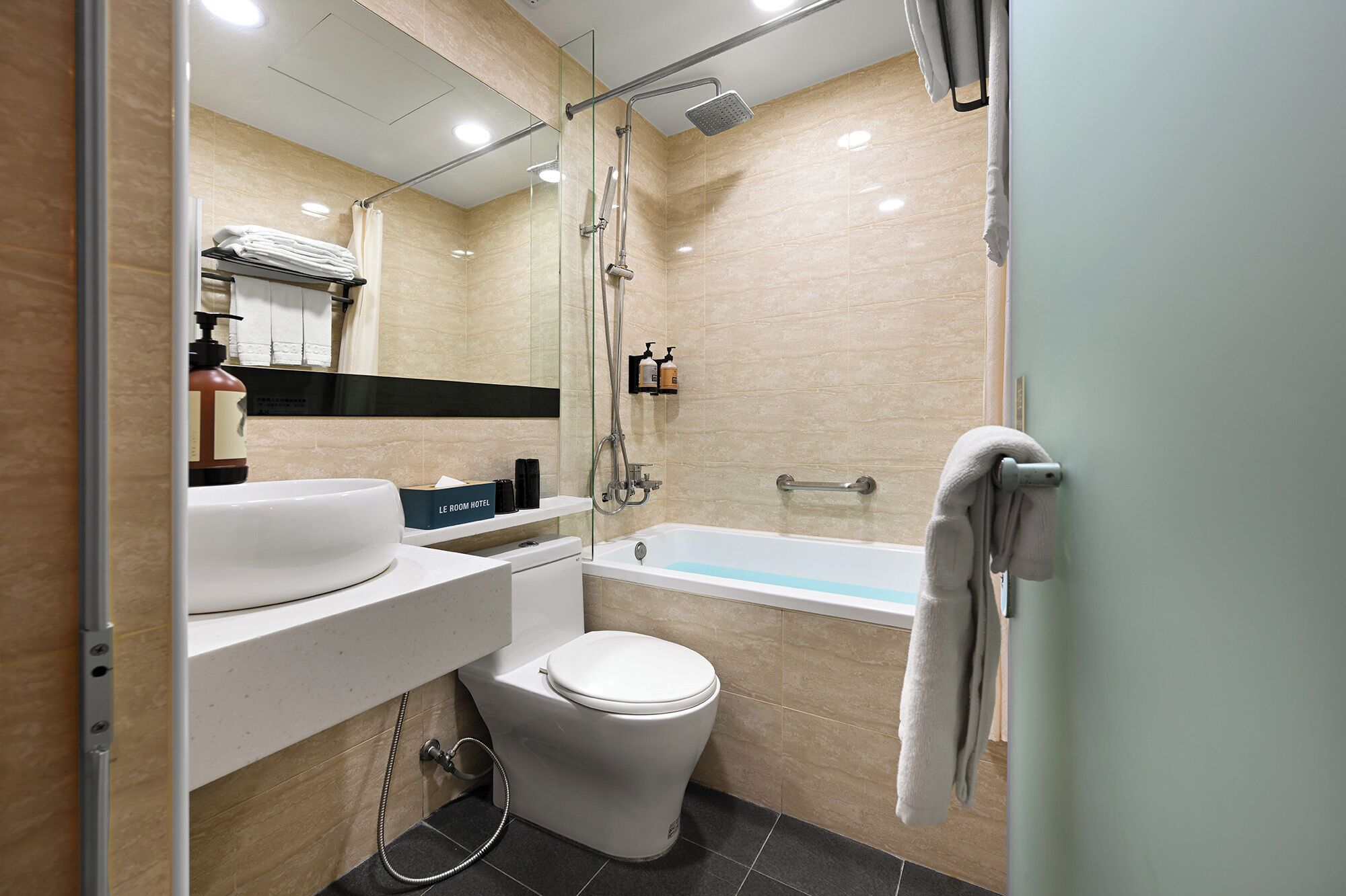 A modern bathroom with a bathtub, toilet, and sink.