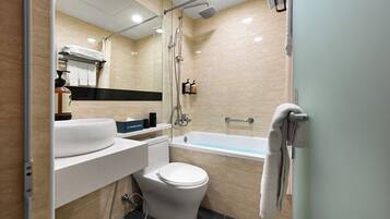 A modern bathroom with a bathtub, toilet, and sink.