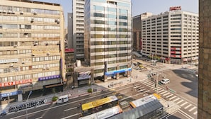 A multi-story building with a modern glass facade, several air conditioning units, and a visible sign for a hotel. - Bon Hotel Taipei (Taipei)