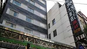 A hotel with a modern facade, multiple floors, and a prominent sign indicating it is a large hotel.