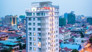 A tall hotel with multiple floors, balconies, and a rooftop terrace. - Relax Hotel (Phnom Penh)