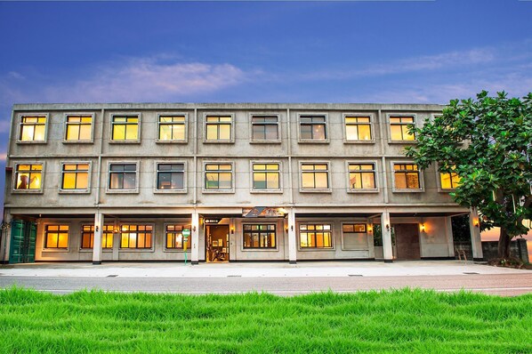 A multi-story building with a flat facade, evenly spaced windows, and a central entrance. - The Leaf Inn (Hualien City)