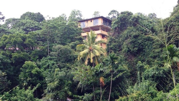 A multi-story building surrounded by dense tropical vegetation. - Kandy View Hotel (Kandy)