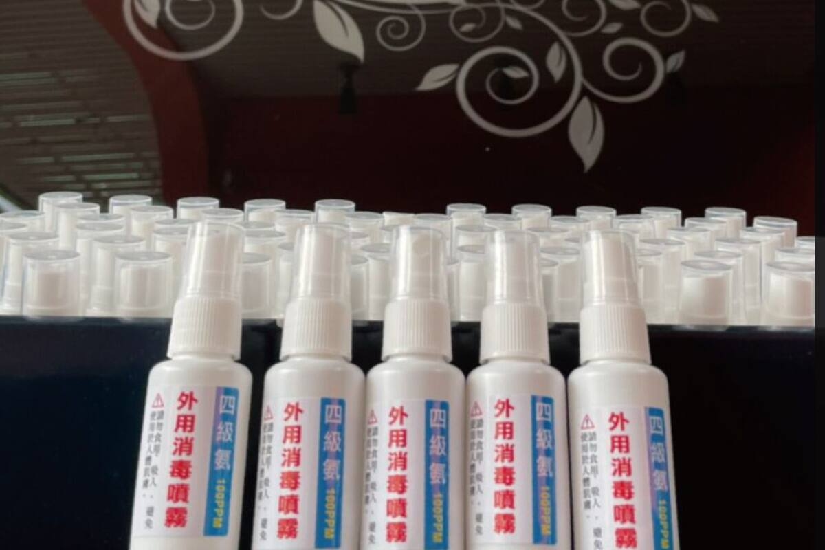 A display of white bottles with red and blue labels, arranged in rows on a shelf.