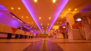 A spacious hall with a high ceiling and rows of chairs. - Sevonra Garden (Unawatuna)