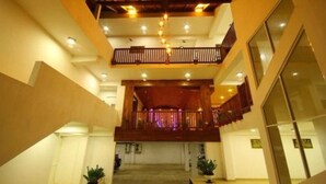 A spacious interior with a central open area, multiple balconies, and a modern ceiling design. - Sevonra Garden (Unawatuna)