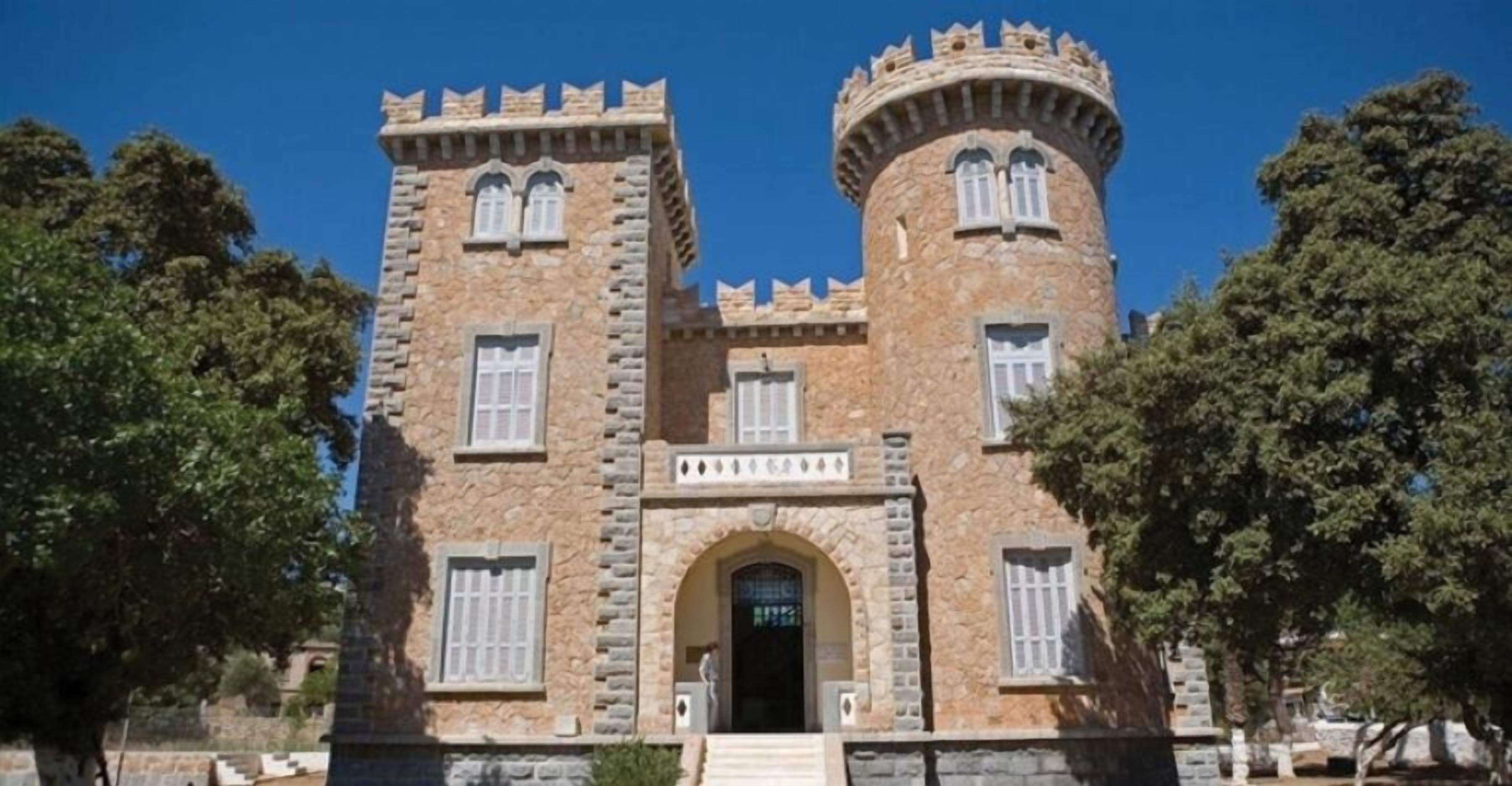 A stone building with two towers and a central entrance.