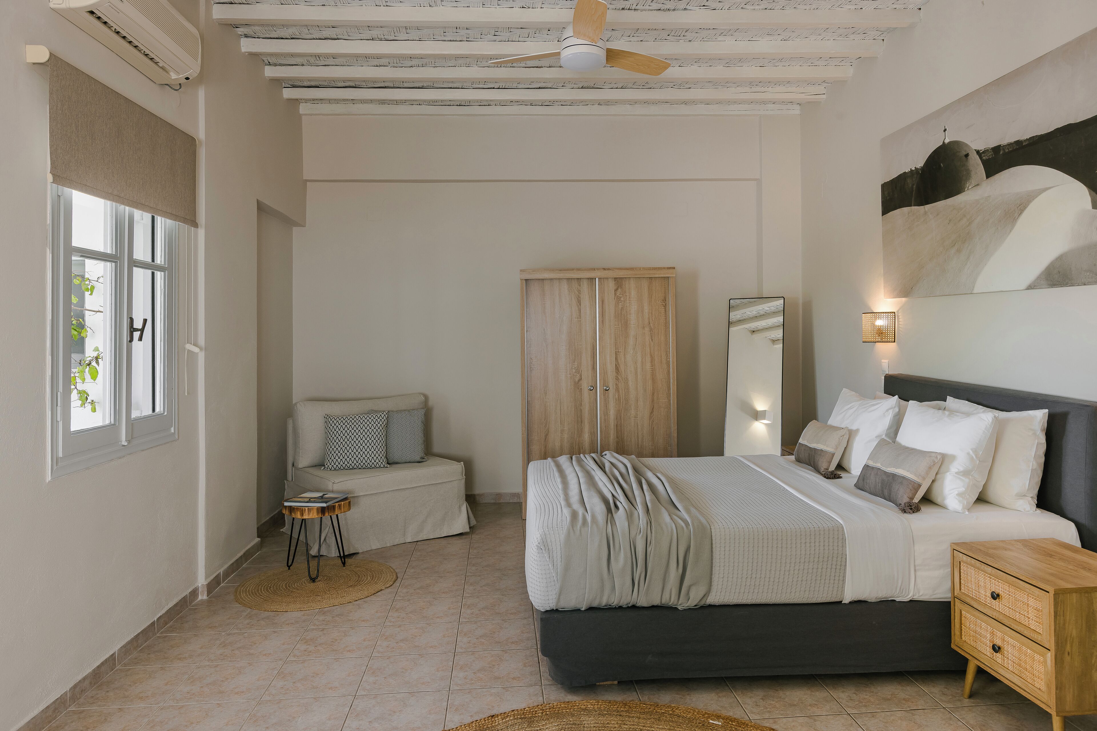 A bedroom with a bed, bedside table, and a wardrobe.