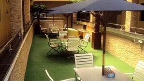 A rooftop terrace with outdoor seating and a barbecue area. - Prixair Pure Hotel Wuse (Abuja)
