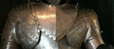 Armadura de caballero medieval, que incluye casco, protecciones para los hombros y una pieza para el pecho.