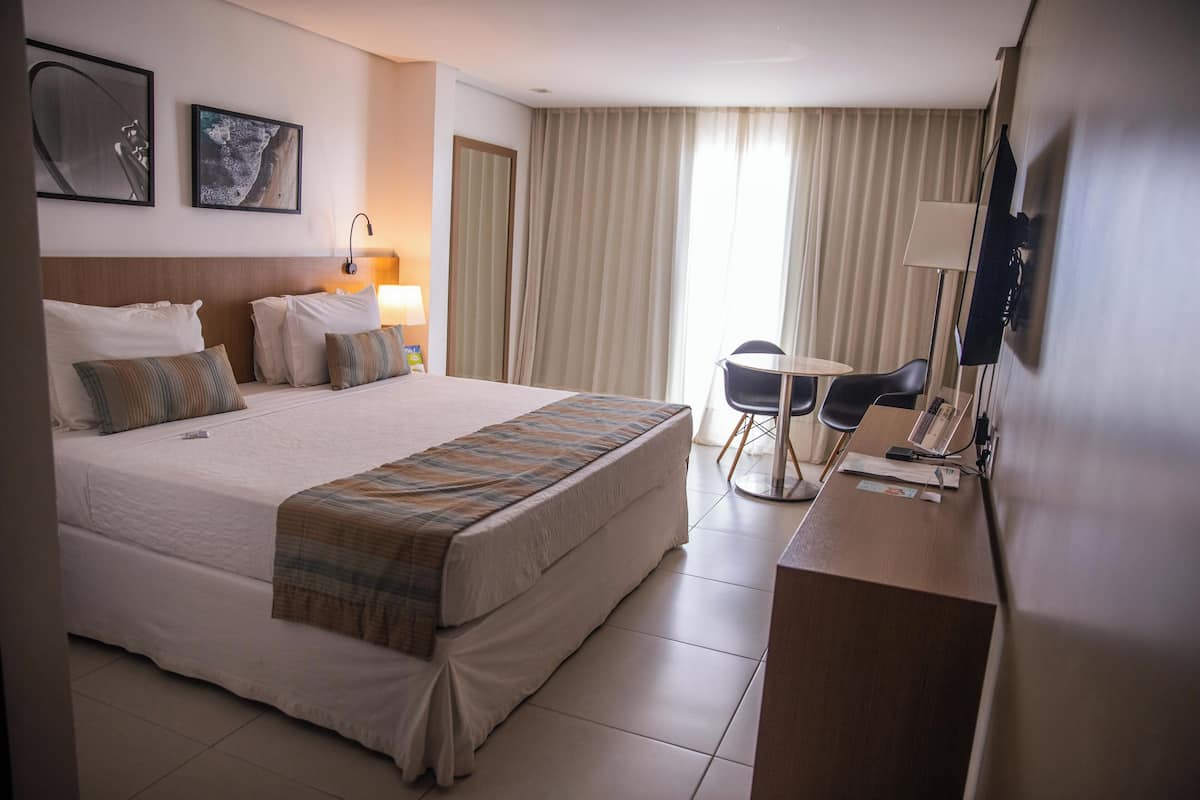 Deluxe Room, Pool View | Minibar, in-room safe, individually decorated, individually furnished