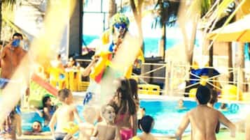 Enjoy a fun-filled day at Espace Aquacroco's water play area, surrounded by palm trees and a stunning sea view.