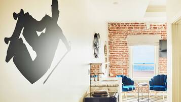 A modern kitchen with a brick wall, a large window, and a view of the beach.