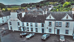 A white building with blue trim and a sign reading "The Ship Inn". There are three cars parked in front. - The Ship Inn (Castle Douglas)